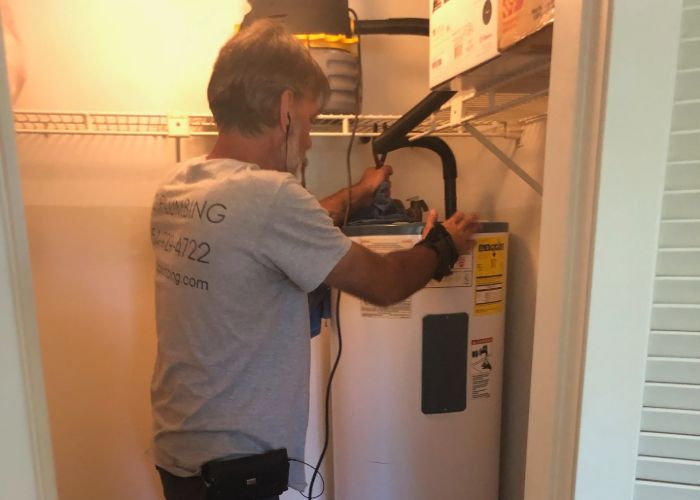 plumber working on water heater installation in Hollywood, FL